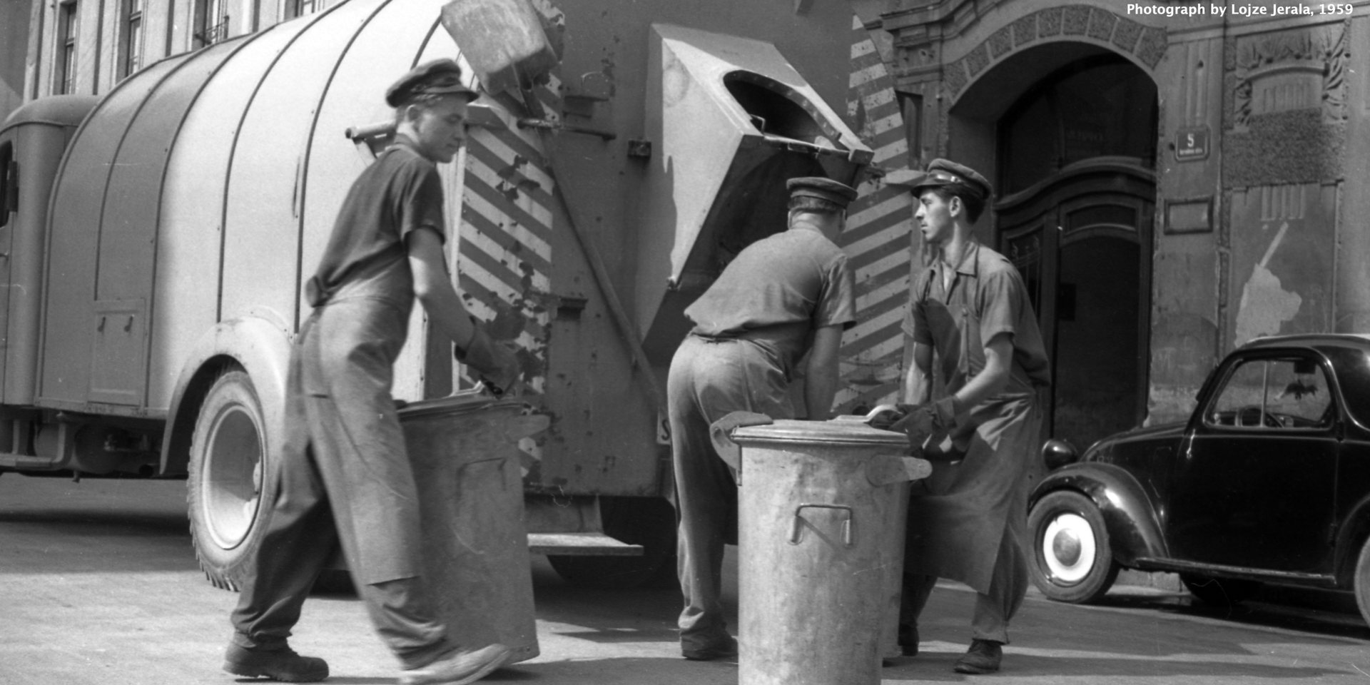 A photograph by Lojze Jerala, of bins being emptied into a lorry in Ljubljana, Slovenia, 1959